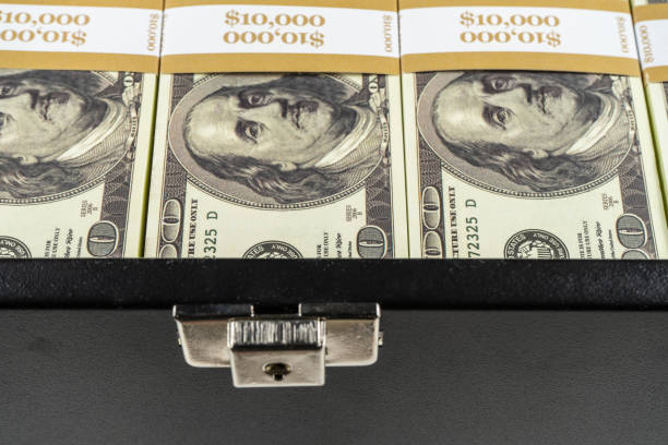 istock Black case full of dollar bills close up.Money bricks in case 1146862567