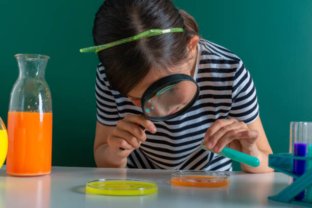 istock happy little girl  in chemistry class making experiments 1146862787