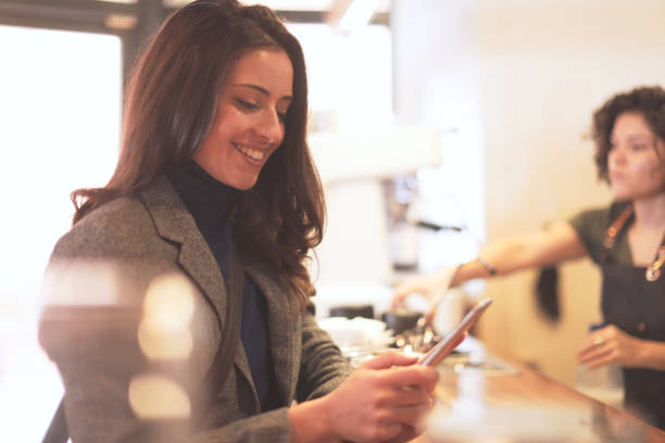 istock Coffee shop customer using a smart phone. 1146863518