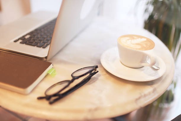 istock Latte art, coffee cup and laptop in a cafeteria. 1146863522