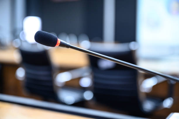 istock Microphone over the blurred business forum Meeting or Conference Training Learning Coaching Room Concept, Blurred background. 1146863592