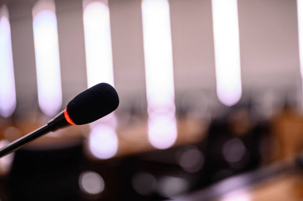 istock Microphone over the blurred business forum Meeting or Conference Training Learning Coaching Room Concept, Blurred background. 1146863597
