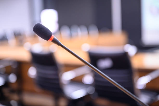 istock Microphone over the blurred business forum Meeting or Conference Training Learning Coaching Room Concept, Blurred background. 1146863720