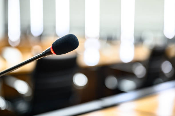 istock Microphone over the blurred business forum Meeting or Conference Training Learning Coaching Room Concept, Blurred background. 1146863812