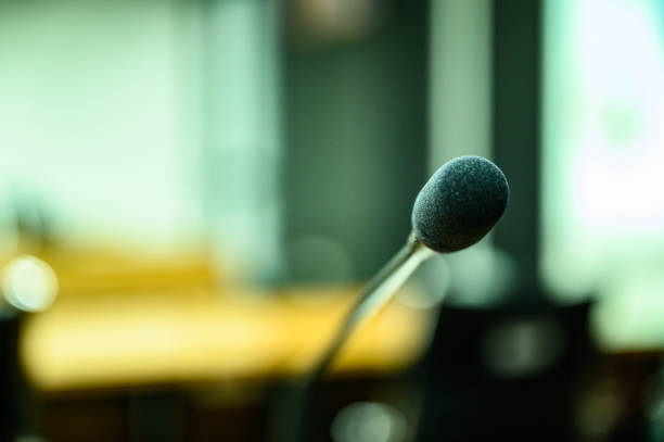 istock Microphone over the blurred business forum Meeting or Conference Training Learning Coaching Room Concept, Blurred background. 1146863840