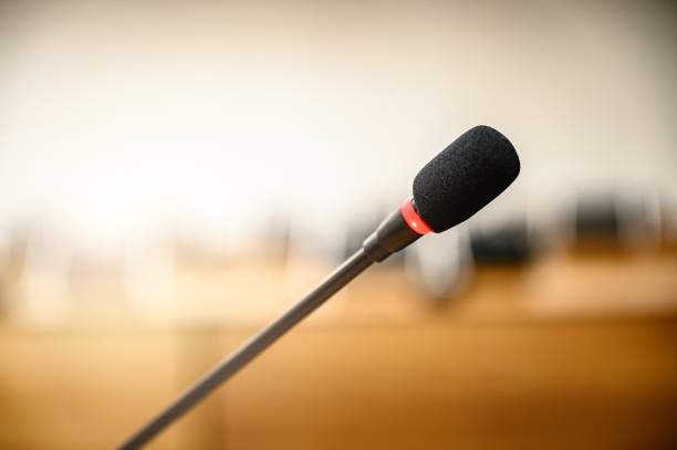 istock Microphone over the blurred business forum Meeting or Conference Training Learning Coaching Room Concept, Blurred background. 1146863900