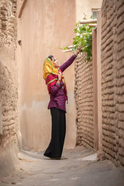 Photo of young beautiful iranian lady outside in an old village