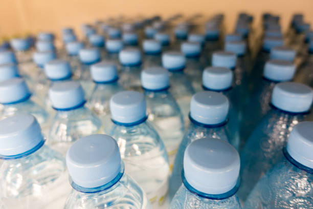 istock Lid plastic water bottle in the market. multi-colored plastic bottle caps 1146877227