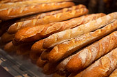 loaf long or baguette of white bread. Golden, fresh, floured and crispy bakery products.