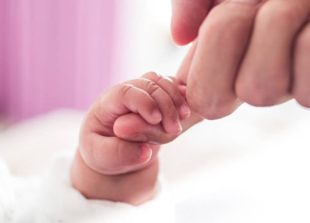 istock Baby holding father finger 1146878618