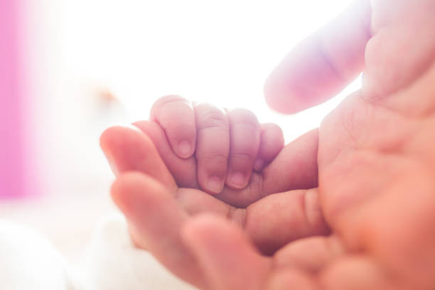 istock Baby holding father finger 1146878634