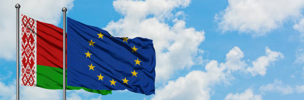 Belarus and European Union flag waving in the wind against white cloudy blue sky together. Diplomacy concept, international relations. Belarus and European Union flag waving in the wind against white cloudy blue sky together. Diplomacy concept, international relations. consul photos stock pictures, royalty-free photos & images