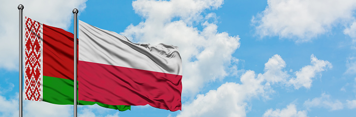 Belarus and Poland flag waving in the wind against white cloudy blue sky together. Diplomacy concept, international relations.