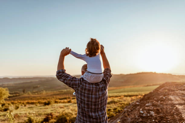 istock Father and baby outdoors in sunset 1146886593
