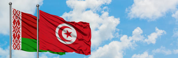 istock Belarus and Tunisia flag waving in the wind against white cloudy blue sky together. Diplomacy concept, international relations. 1146886607