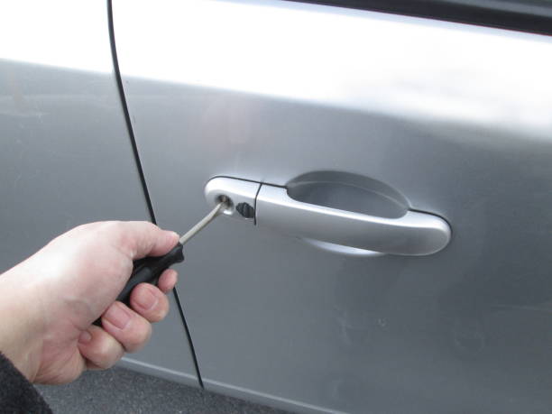 Man hand holding car key, isolated on white background