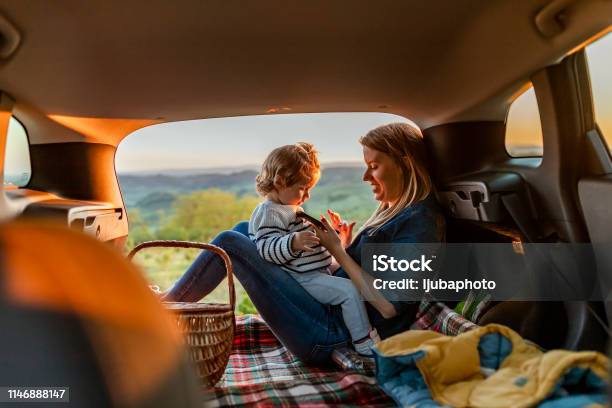 Mother And Son With Pad During Car Travel At Night Stock Photo - Download Image Now - Car, Family, Autumn