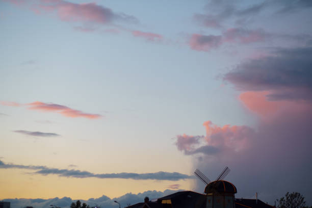 Pink vivid sunset with a mill in the background - Rainy clouds taking over in this beautiful landscape scenery of our nature Pink vivid sunset with a mill in the background - Rainy clouds taking over in this beautiful landscape scenery of our nature - Colorful sunrise - Video footage from this set is available too. dorchester on thames stock pictures, royalty-free photos & images