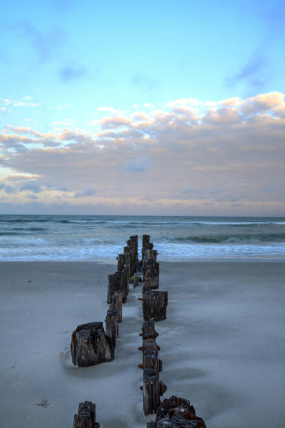 istock Dawn over a dilapidated pier on the beach in Port Royal 1146892688