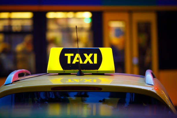 istock Yellow taxi cab with blurry tram 1146893031