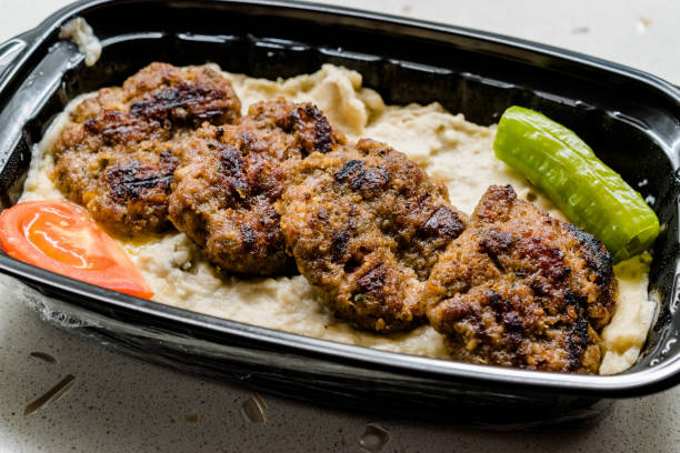 Turkish Fast Food Kofte / Kofta with Roasted Eggplant Hunkar Begendi in Plastic Cup / Container. (Aubergine Kebab or Kebap) Turkish Fast Food Kofte / Kofta with Roasted Eggplant Hunkar Begendi in Plastic Cup / Container. (Aubergine Kebab or Kebap). Traditional Meat Food. hunkar begendi stock pictures, royalty-free photos & images