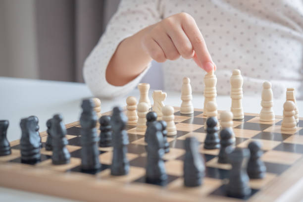 istock a girl learn how to play chess game 1146900011