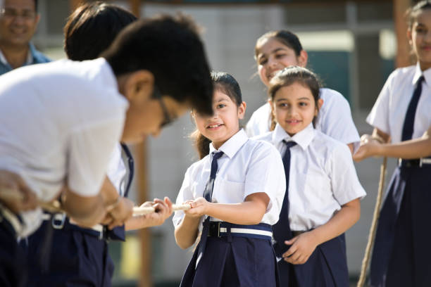 istock Cheering student playing tug of war 1146900168