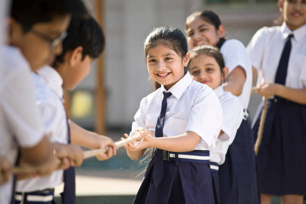istock Cheering student playing tug of war 1146900181