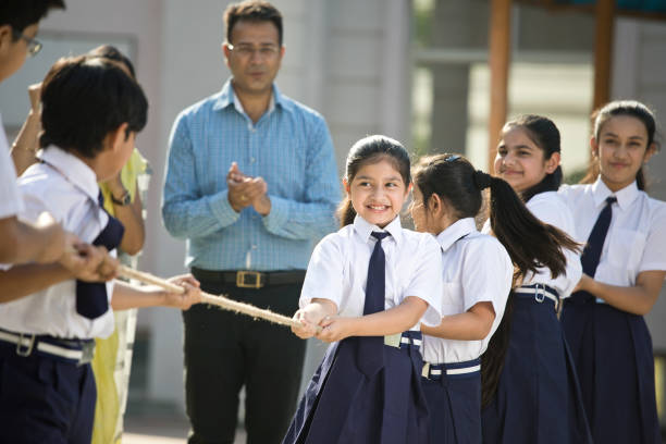 istock Teachers cheering student playing tug of war 1146900204