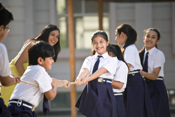 istock Teacher cheering student playing tug of war 1146900251
