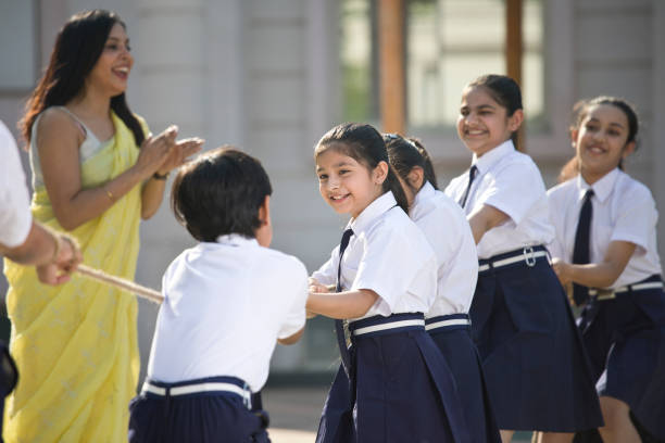 istock Teacher cheering student playing tug of war 1146900273