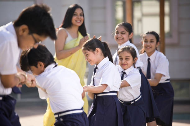 istock Teacher cheering student playing tug of war 1146900316