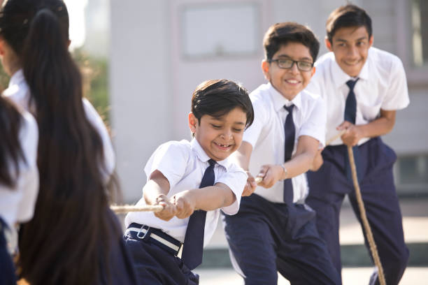istock Cheering student playing tug of war 1146900917