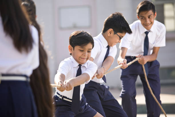 istock Cheering student playing tug of war 1146901458