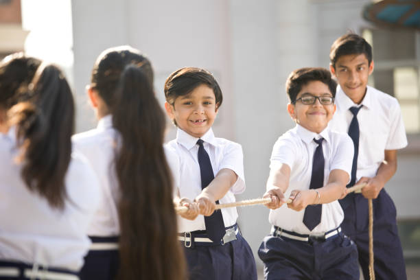 istock Cheering student playing tug of war 1146901500
