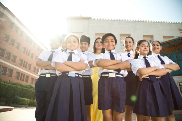 istock School children posing with teacher in campus 1146902049