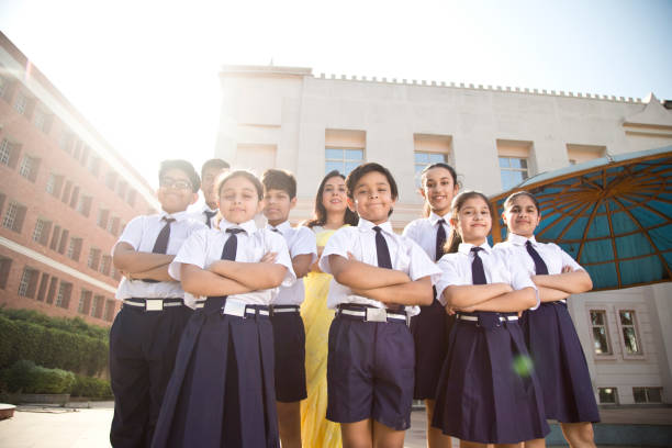 istock School children posing with teacher in campus 1146902085