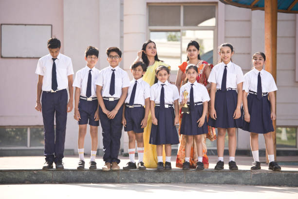 istock School children posing with teacher in campus 1146902370