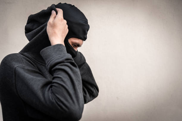 istock The thief is removing the mask. 1146902446