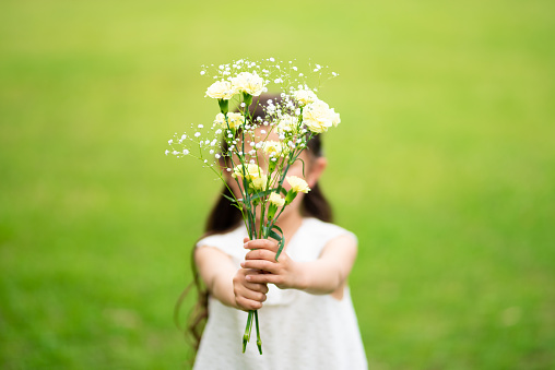 Girl handing over a bouquet