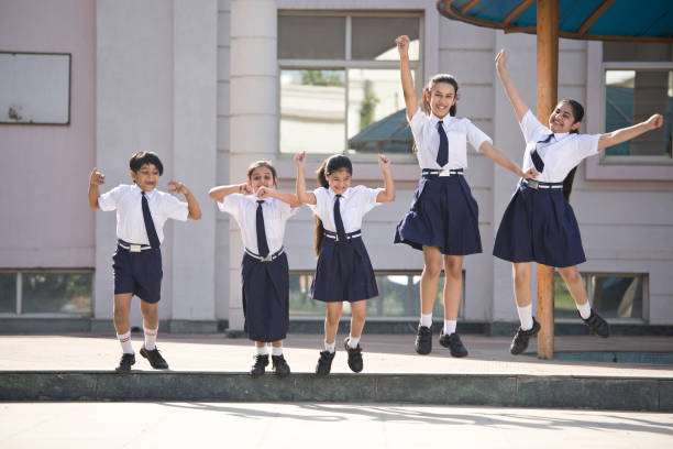 istock School children jumping and celebrating in school campus 1146902501