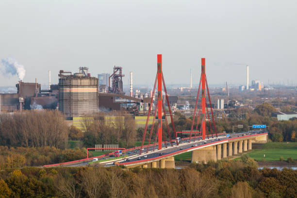 Steel Plant at the river Rhine near Duisburg, Germany with the motorway bridge of the A42 in the foreground.