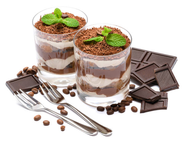 two portions Classic tiramisu dessert in a glass and chocolate bar isolated on a white background