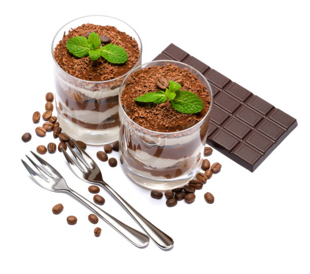 two portions Classic tiramisu dessert in a glass and chocolate bar isolated on a white background