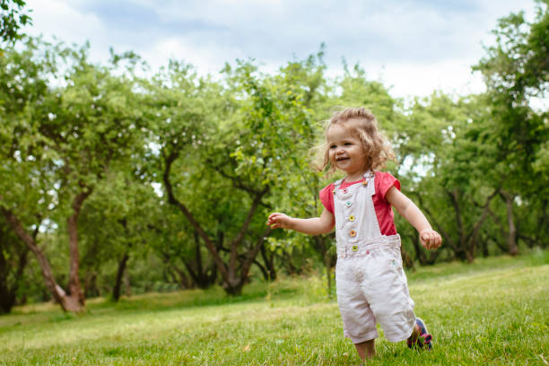 istock Cute child running in park in springtime 1146903806