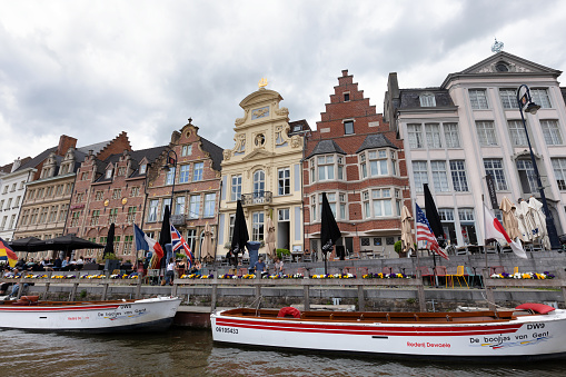 Ghent, Belgium - April 24th, 2019: View at the old commercial docks of the city of Ghent,  the city and water from a tour boat.