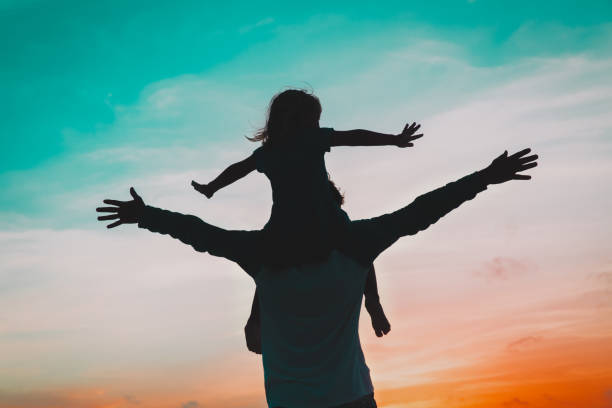 istock father and little daughter play at sunset sky 1146906620