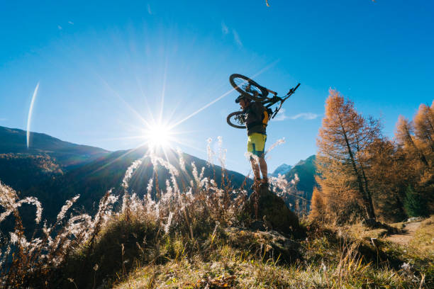 istock Mountain biker carries bike off trail 1146909478