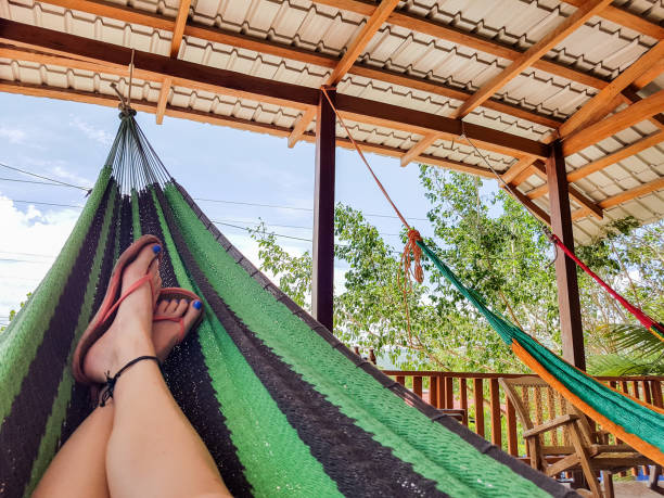 Low section of woman lying in hammock