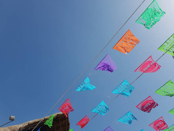 low angle view of colorful flags against blue sky